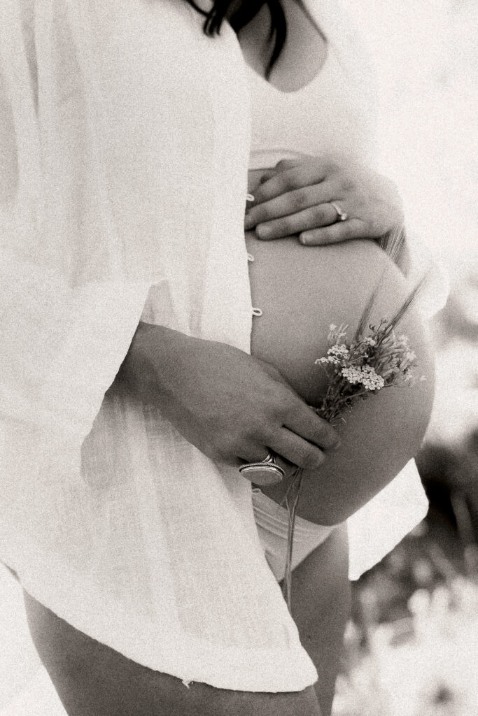 Maternity Photographer, a pregnant woman holds her belly