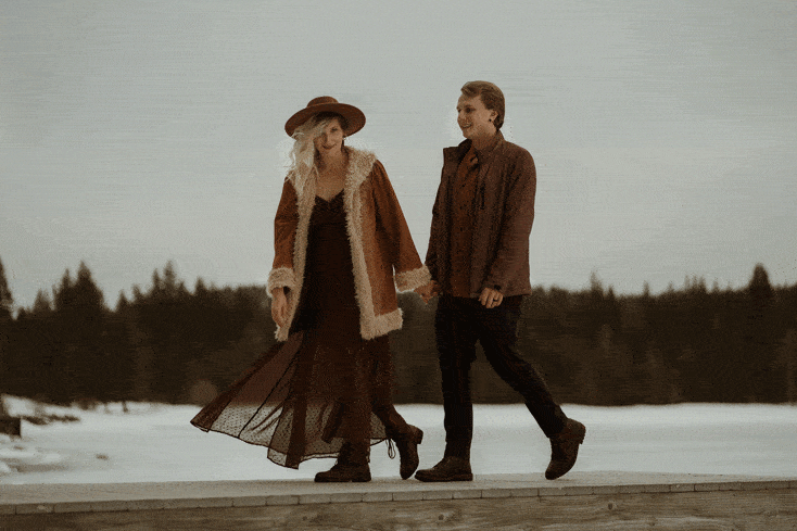 An animated gif of a couple, man and woman, walking through the wild before forests